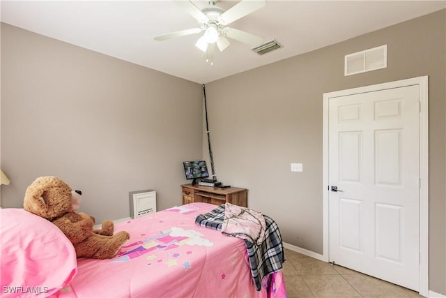 tiled bedroom featuring ceiling fan