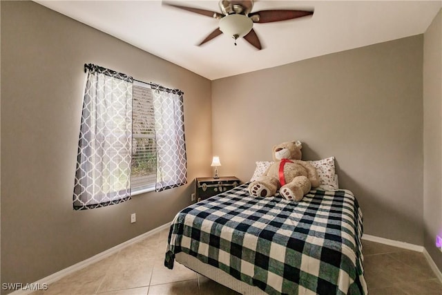 bedroom with ceiling fan and light tile patterned flooring