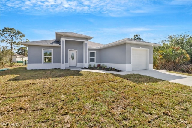 view of front of property with a garage and a front yard