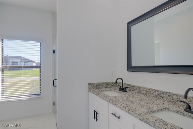 bathroom featuring plenty of natural light and vanity