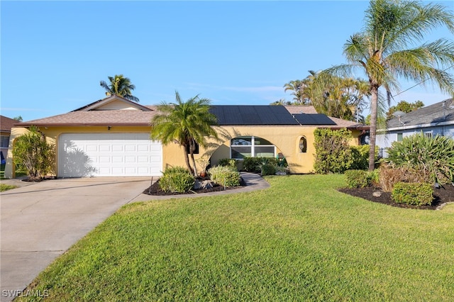 ranch-style home with a front lawn, a garage, and solar panels