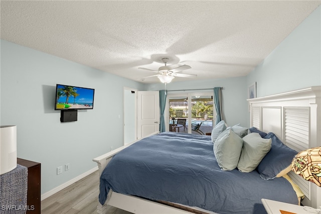 bedroom featuring ceiling fan, a textured ceiling, access to outside, and light hardwood / wood-style flooring