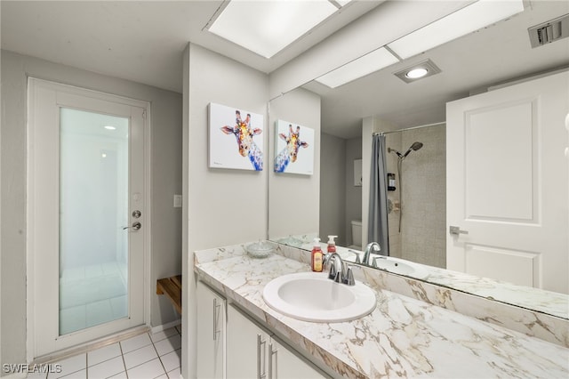 bathroom with tile patterned floors, vanity, a shower with shower curtain, and toilet