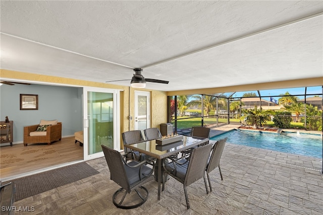 view of pool with pool water feature and ceiling fan