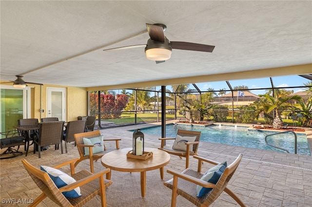 view of swimming pool with a lanai, ceiling fan, and a patio