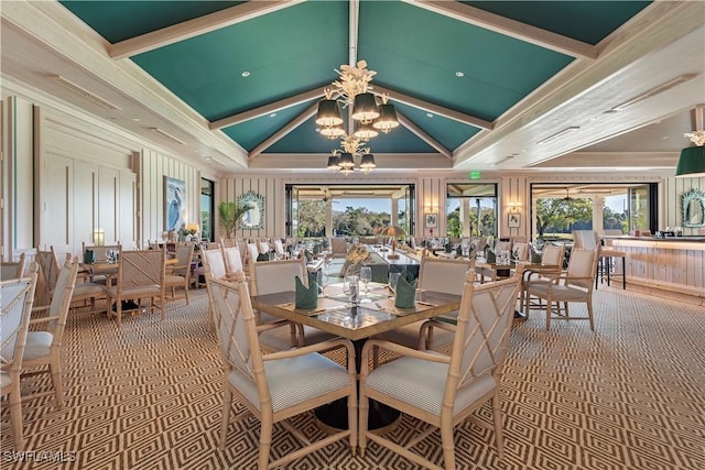 dining area featuring vaulted ceiling, ornamental molding, a notable chandelier, and carpet flooring