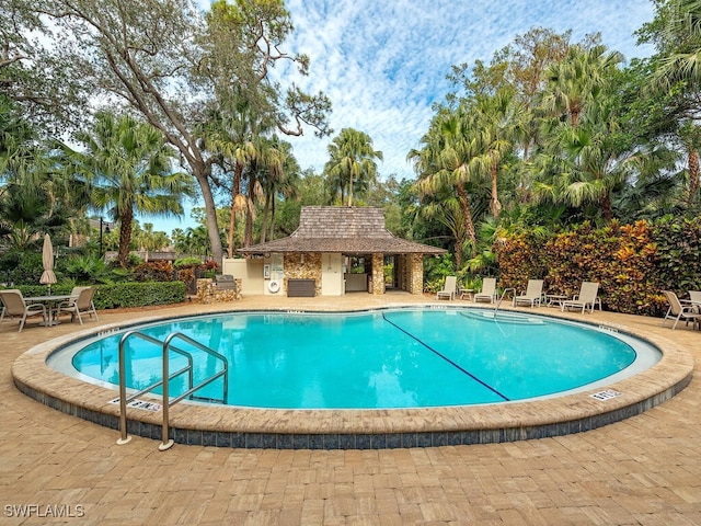 view of swimming pool with a patio area and an outdoor structure