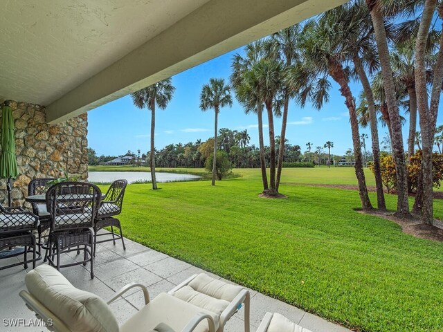 view of yard with a patio and a water view