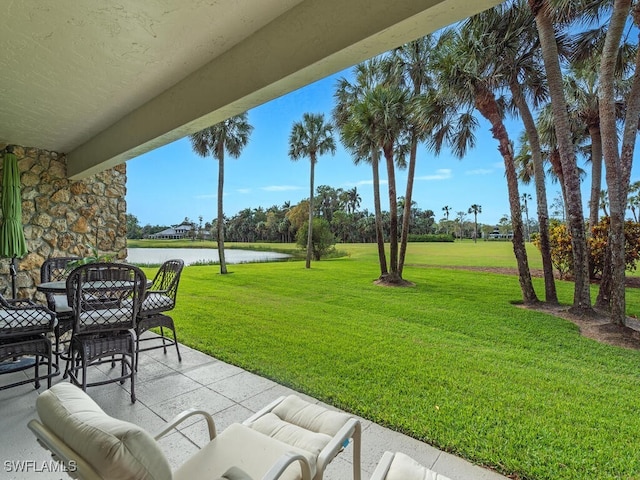 exterior space featuring a water view, a patio, and an outdoor hangout area