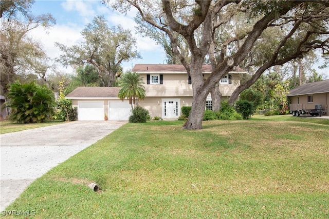 view of front of home with a garage and a front lawn