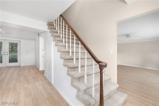 stairs featuring french doors and ceiling fan