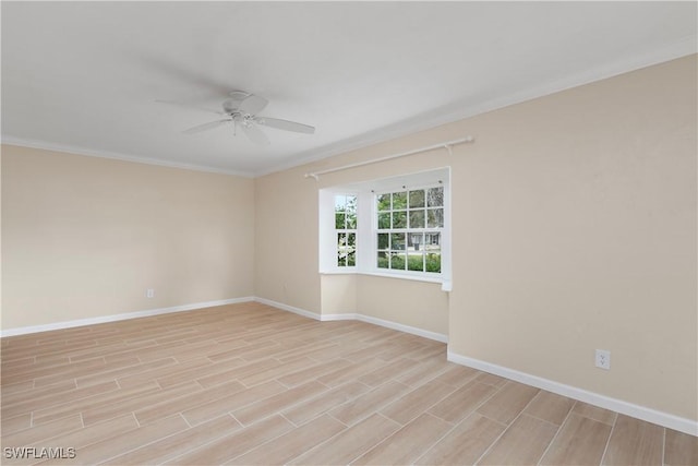 empty room featuring crown molding, light hardwood / wood-style floors, and ceiling fan