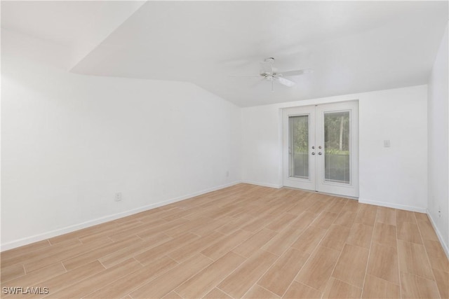 empty room featuring french doors, ceiling fan, lofted ceiling, and light hardwood / wood-style flooring