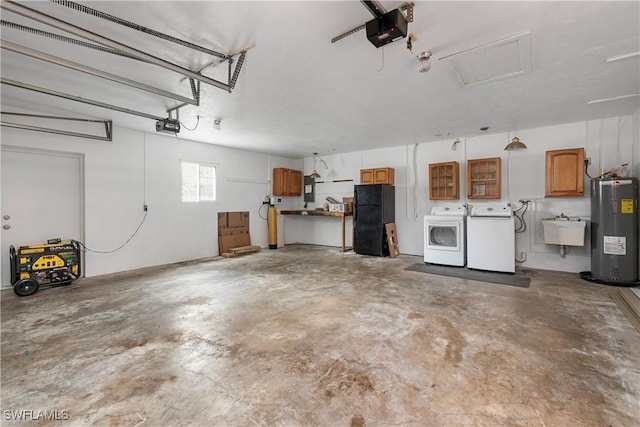 garage with water heater, sink, washing machine and clothes dryer, a garage door opener, and black fridge