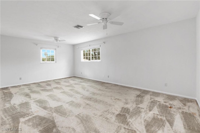 carpeted empty room featuring ceiling fan