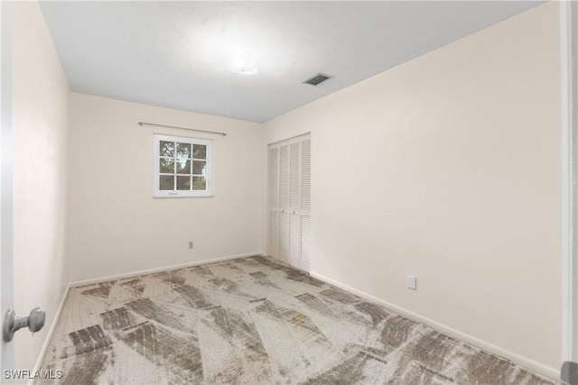 unfurnished room featuring light carpet