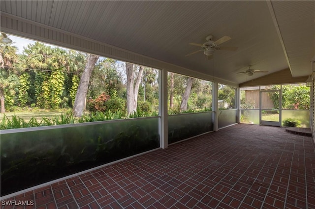 unfurnished sunroom with ceiling fan and vaulted ceiling