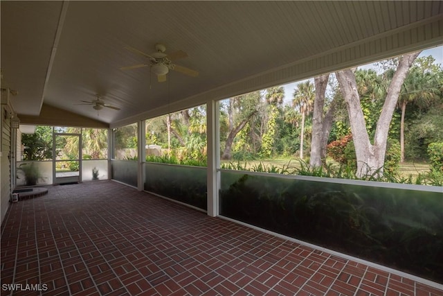 unfurnished sunroom featuring lofted ceiling and ceiling fan