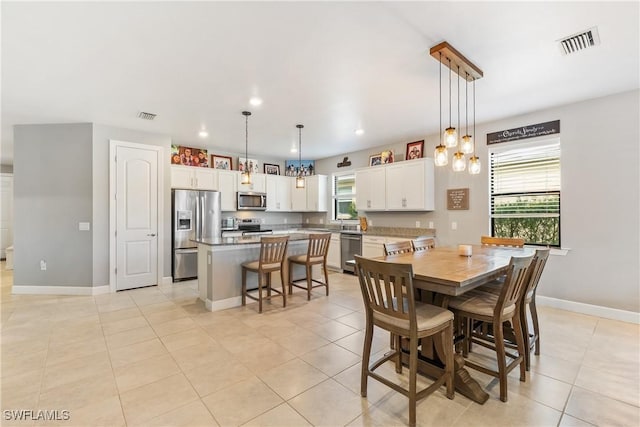 tiled dining area featuring plenty of natural light