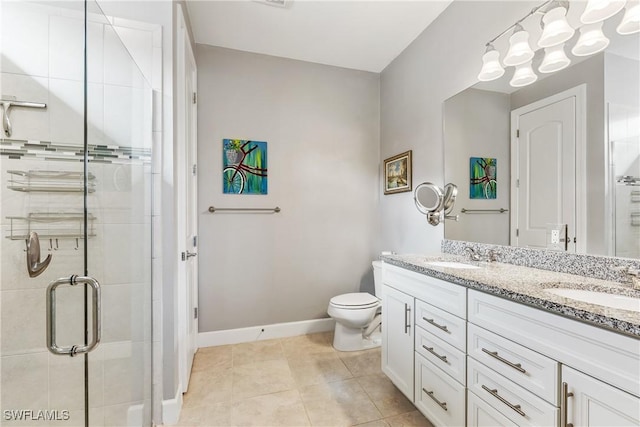 bathroom with tile patterned flooring, vanity, toilet, and walk in shower