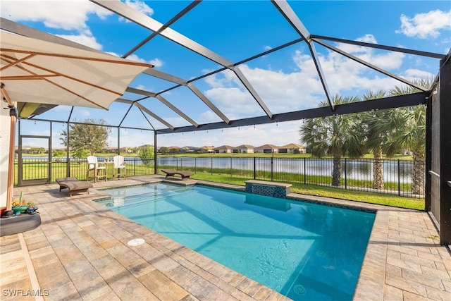 view of swimming pool featuring glass enclosure, a patio area, and a water view