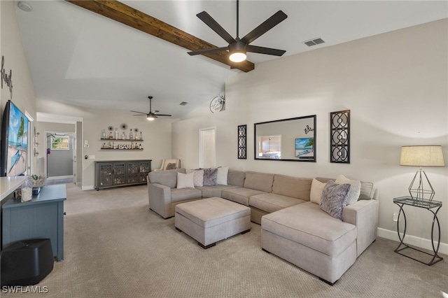 carpeted living room with beamed ceiling and ceiling fan