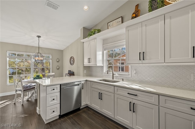 kitchen featuring dishwasher, sink, kitchen peninsula, pendant lighting, and white cabinets