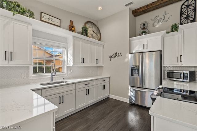 kitchen featuring stainless steel appliances, white cabinetry, dark wood-type flooring, and sink