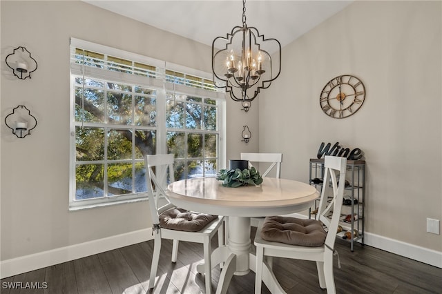 dining area featuring a healthy amount of sunlight, dark wood-type flooring, and a chandelier