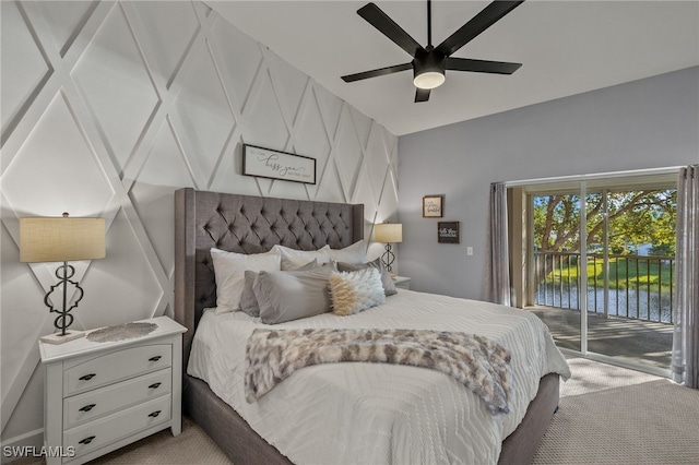 carpeted bedroom featuring access to exterior, ceiling fan, and a water view