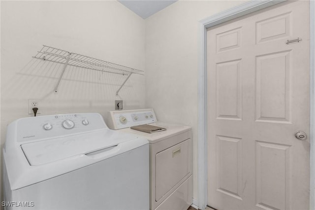 laundry room featuring washing machine and clothes dryer