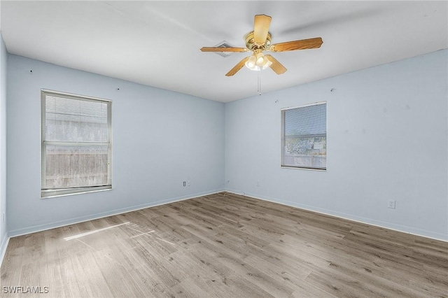 spare room featuring ceiling fan and light hardwood / wood-style floors