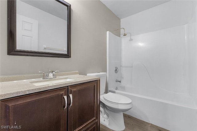 full bathroom featuring hardwood / wood-style floors, vanity, toilet, and tub / shower combination