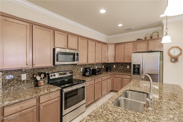 kitchen with decorative light fixtures, stainless steel appliances, ornamental molding, and sink