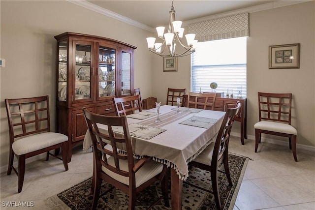 dining space with light tile patterned flooring, ornamental molding, and a chandelier