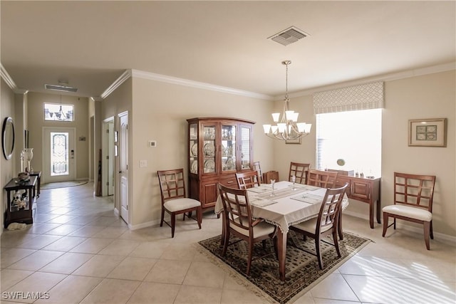 dining room featuring a chandelier, crown molding, and light tile patterned flooring