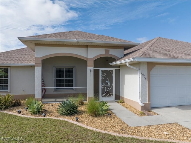 view of front facade featuring a porch and a garage