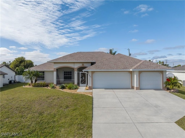 view of front of property featuring a front yard and a garage