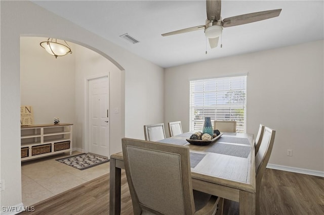 dining area with hardwood / wood-style flooring and ceiling fan