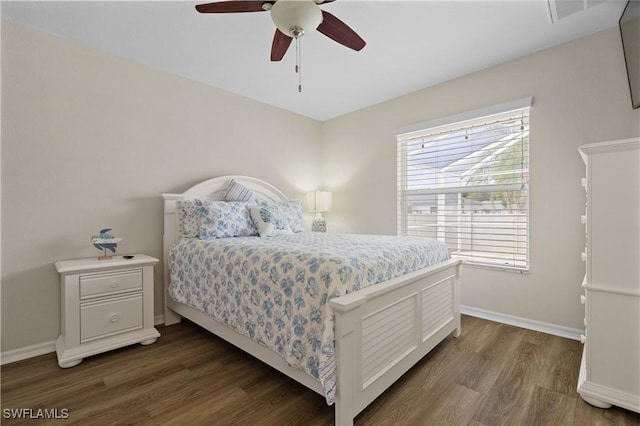 bedroom with ceiling fan and dark wood-type flooring