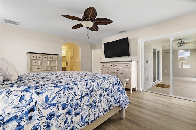 bedroom with ceiling fan, light hardwood / wood-style floors, and a closet