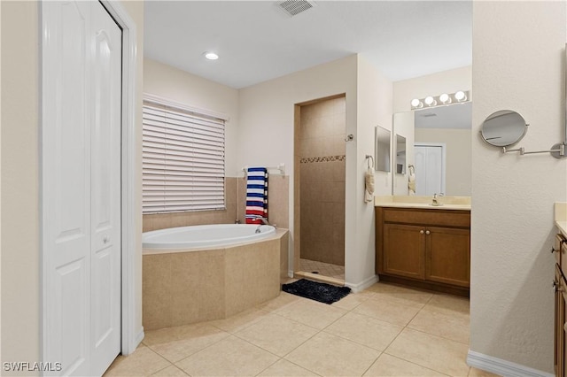 bathroom featuring vanity, tile patterned floors, and separate shower and tub