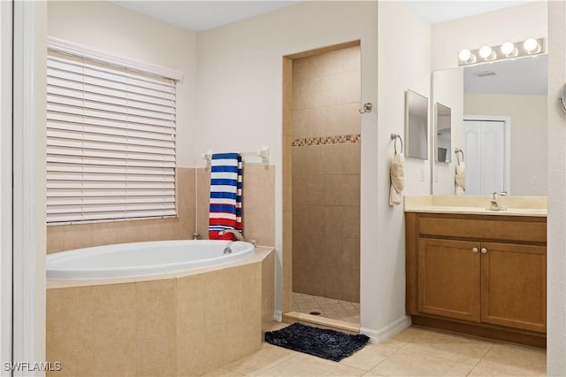 bathroom featuring tile patterned floors, vanity, and plus walk in shower