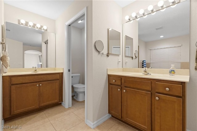 bathroom with tile patterned floors, vanity, and toilet