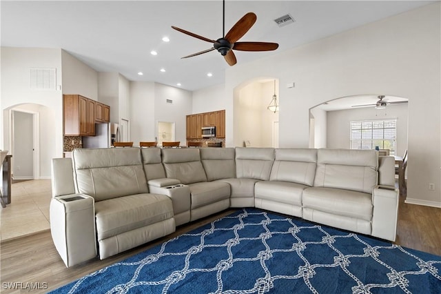 living room with ceiling fan and light hardwood / wood-style flooring