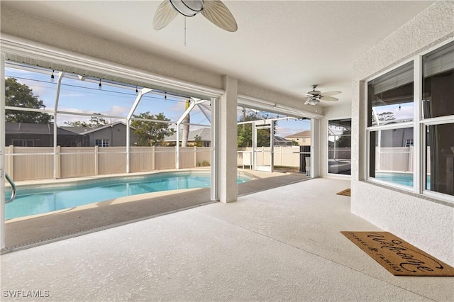 view of pool featuring ceiling fan, a lanai, and a patio