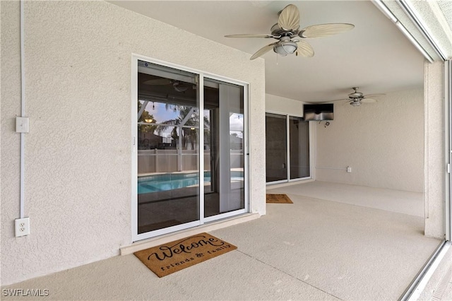 property entrance featuring ceiling fan