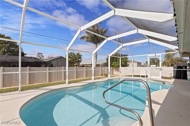 view of swimming pool featuring a patio, central AC unit, and a lanai