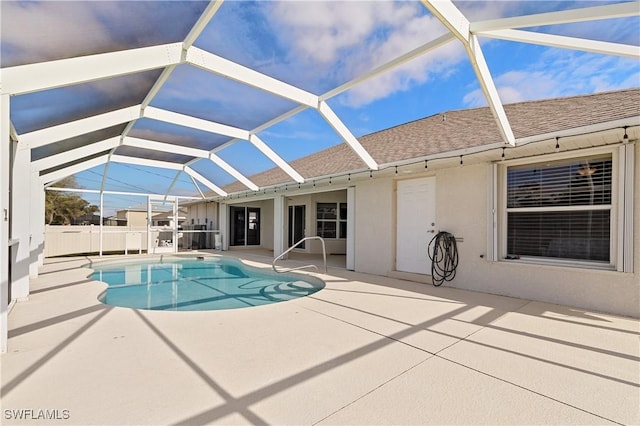 view of pool with a patio area and glass enclosure