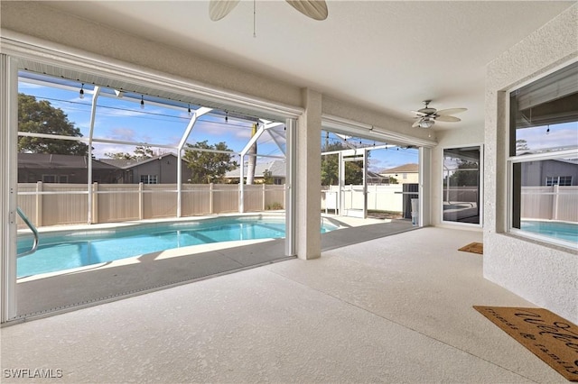 view of pool featuring a lanai, a patio area, and ceiling fan